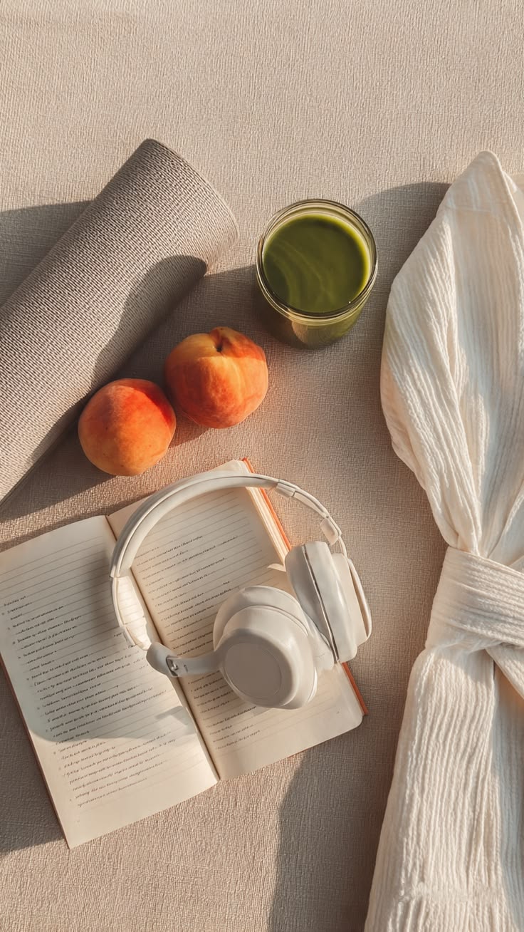 Hands holding a phone beside a journal and tea, suggesting thoughtful cycle tracking beyond a calendar app